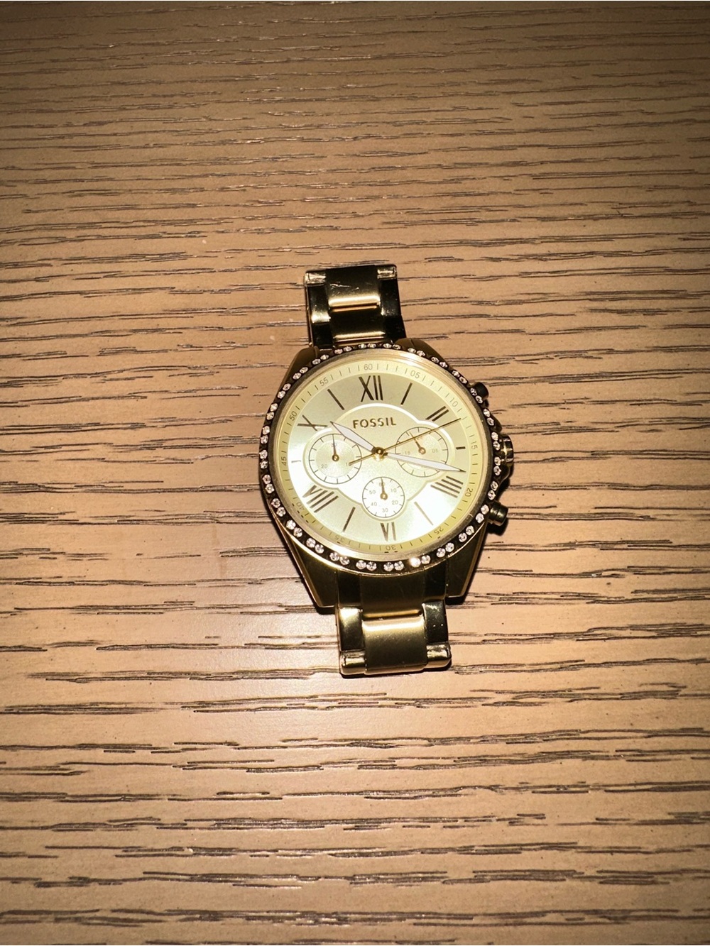 Wristwatch on wooden surface